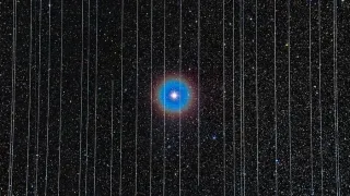The double star Albireo behind vertical Starlink satellite trails