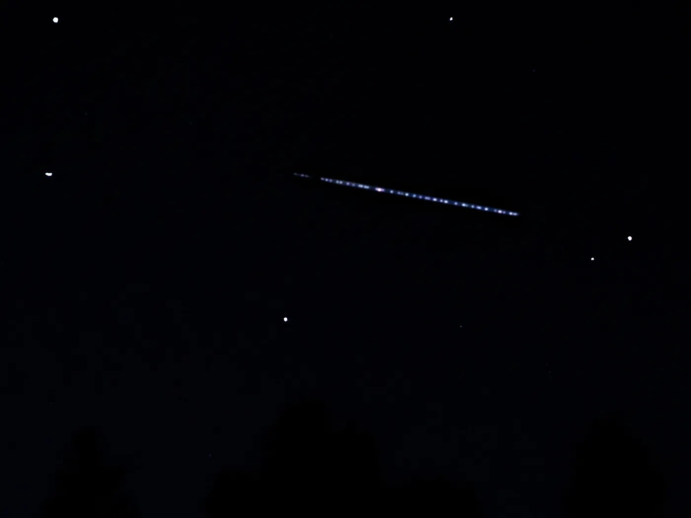 A bright train of Starlink satellites over Lone Pine